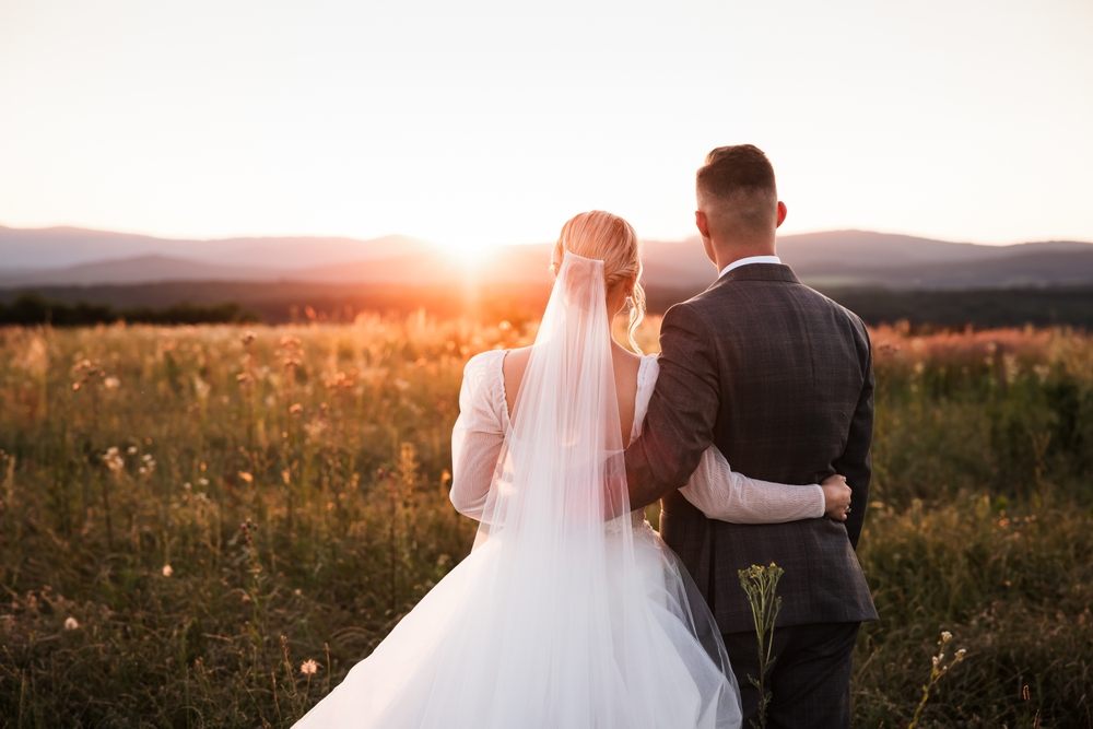 Bride and groom embracing at sunset after covering last-minute costs with a wedding payday loan in Canada