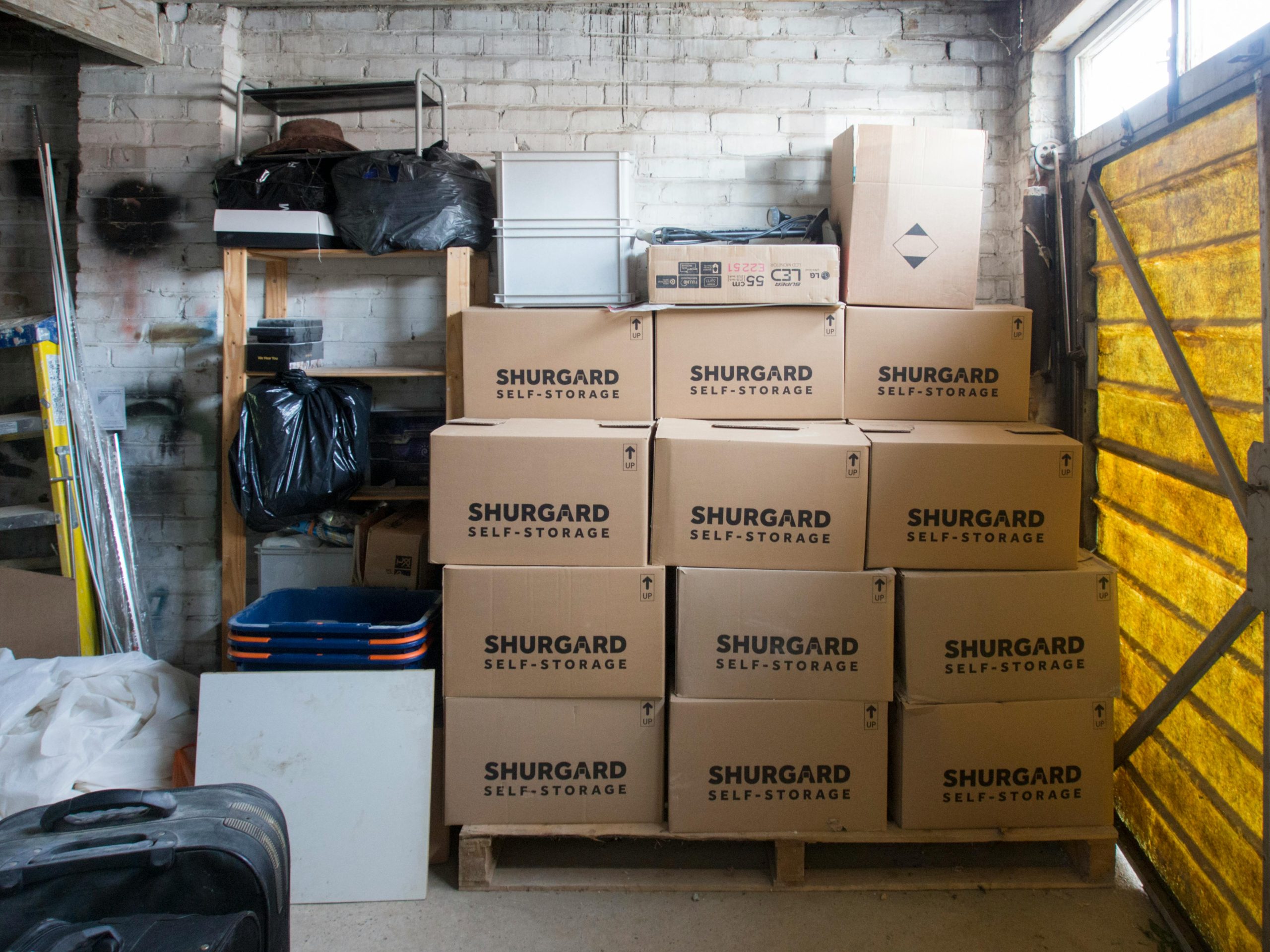 A stack of storage boxes in a well-organized storage unit.
