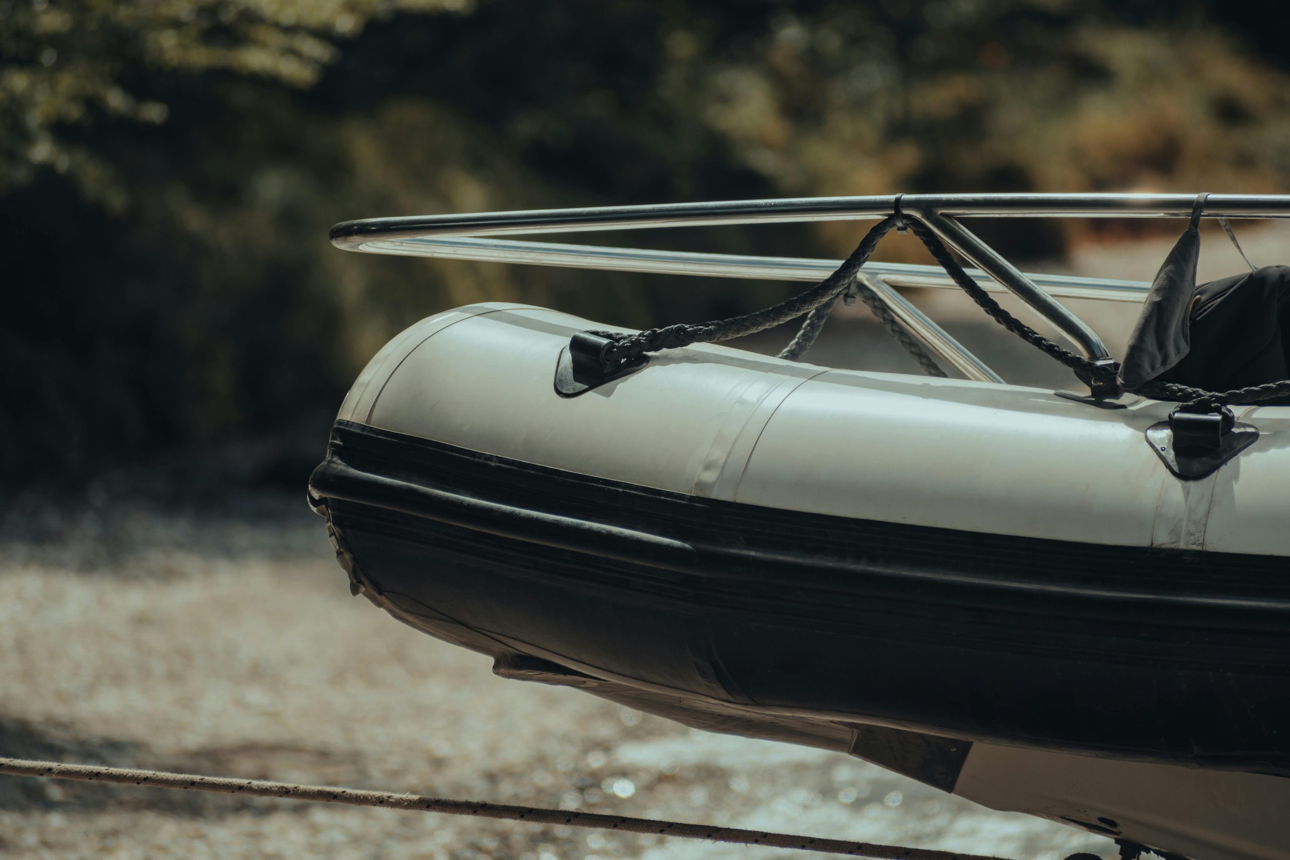 A detailed look at a modern inflatable boat tied at a riverbank
