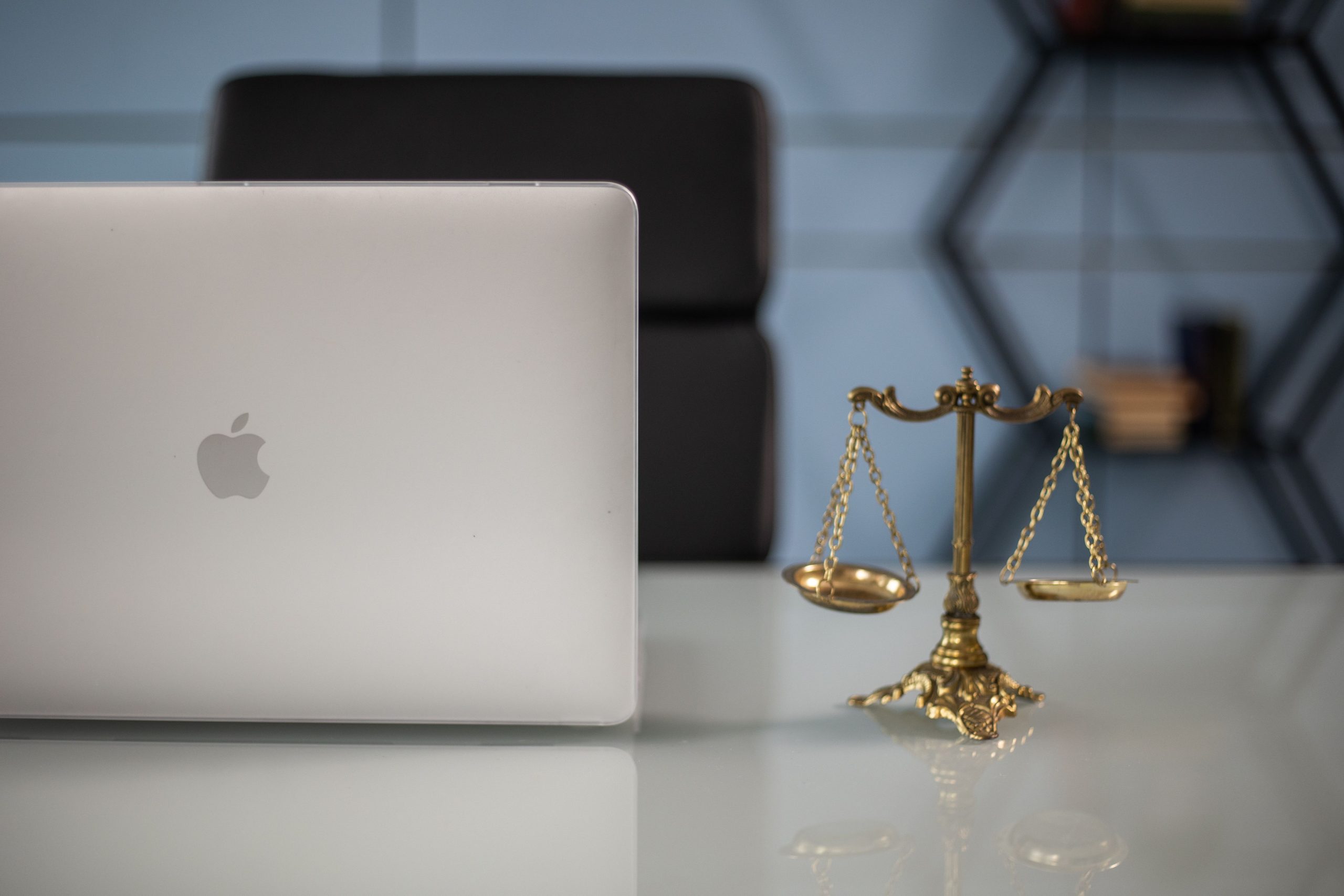 Elegant balance of technology and justice scales on an office desk